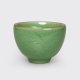 Jade green porcelain cup with craquelure glaze which changes over time.